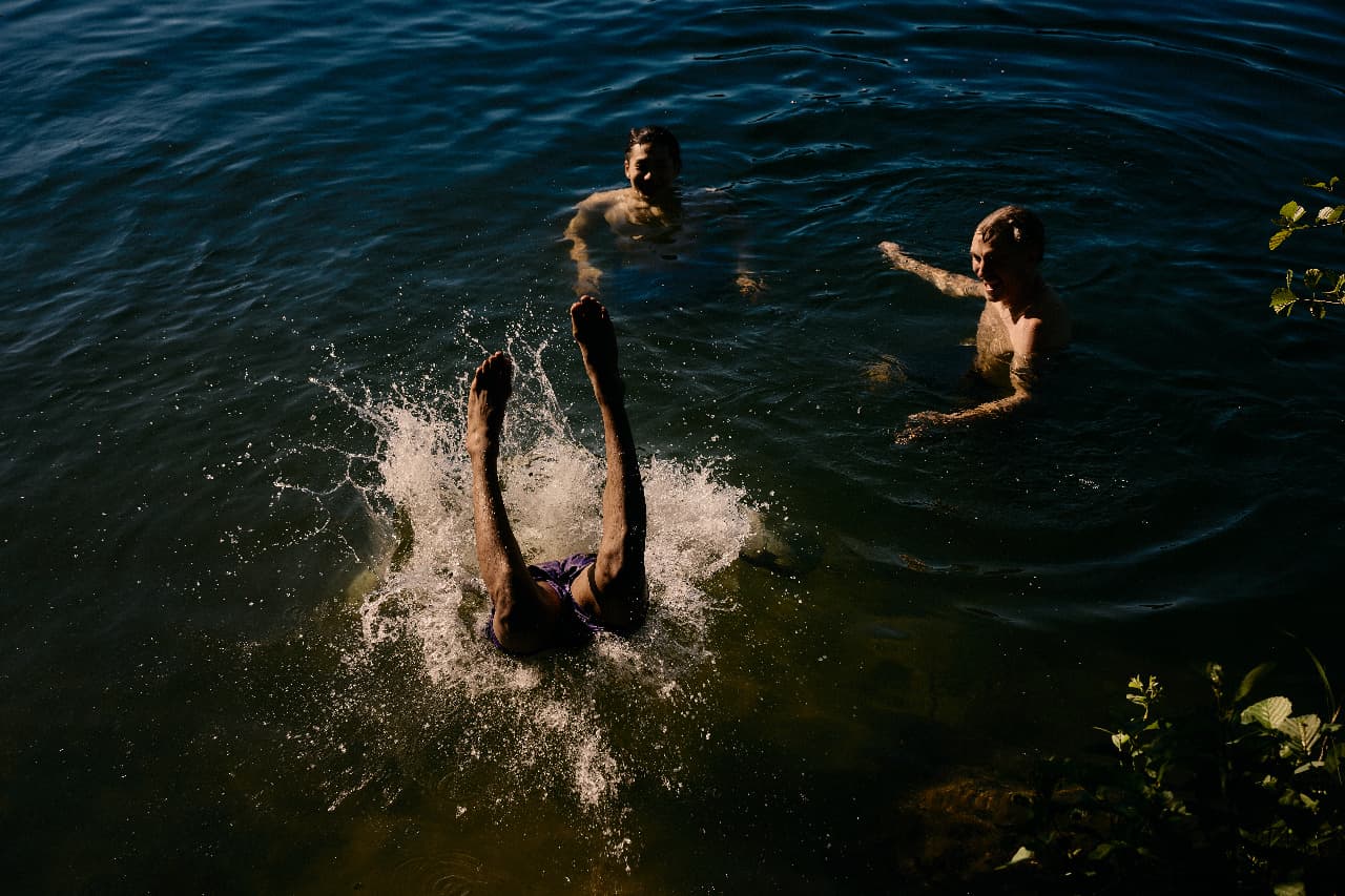Friends swimming together in dark water