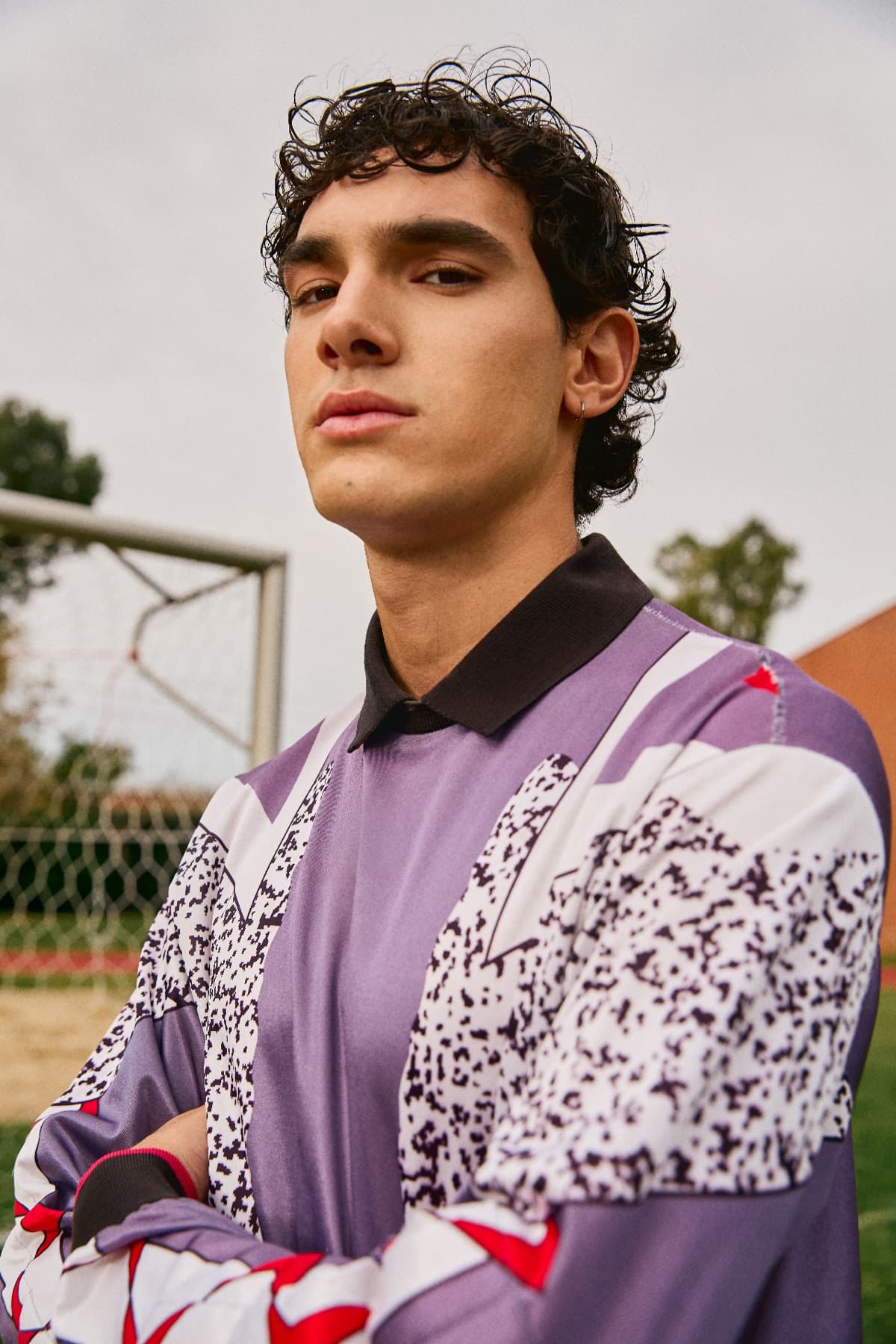 Athlete standing beside an outdoor sports court
