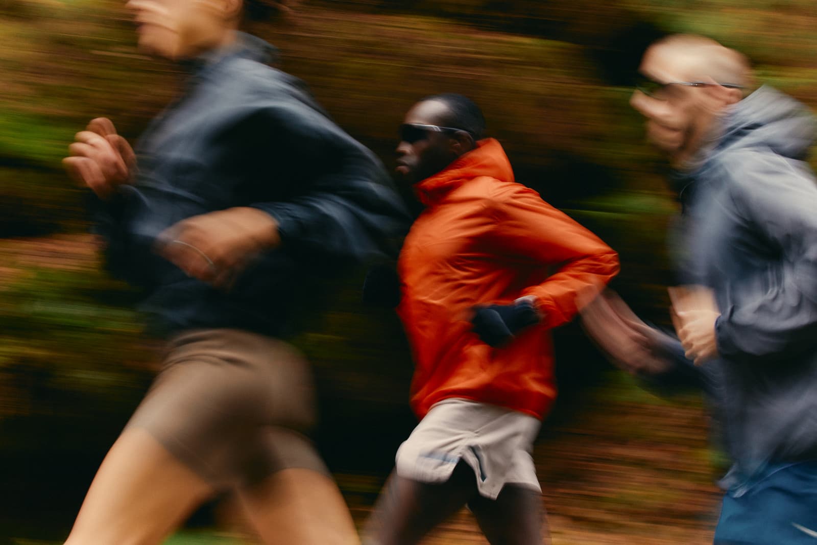 Three runners moving together, captured with motion blur