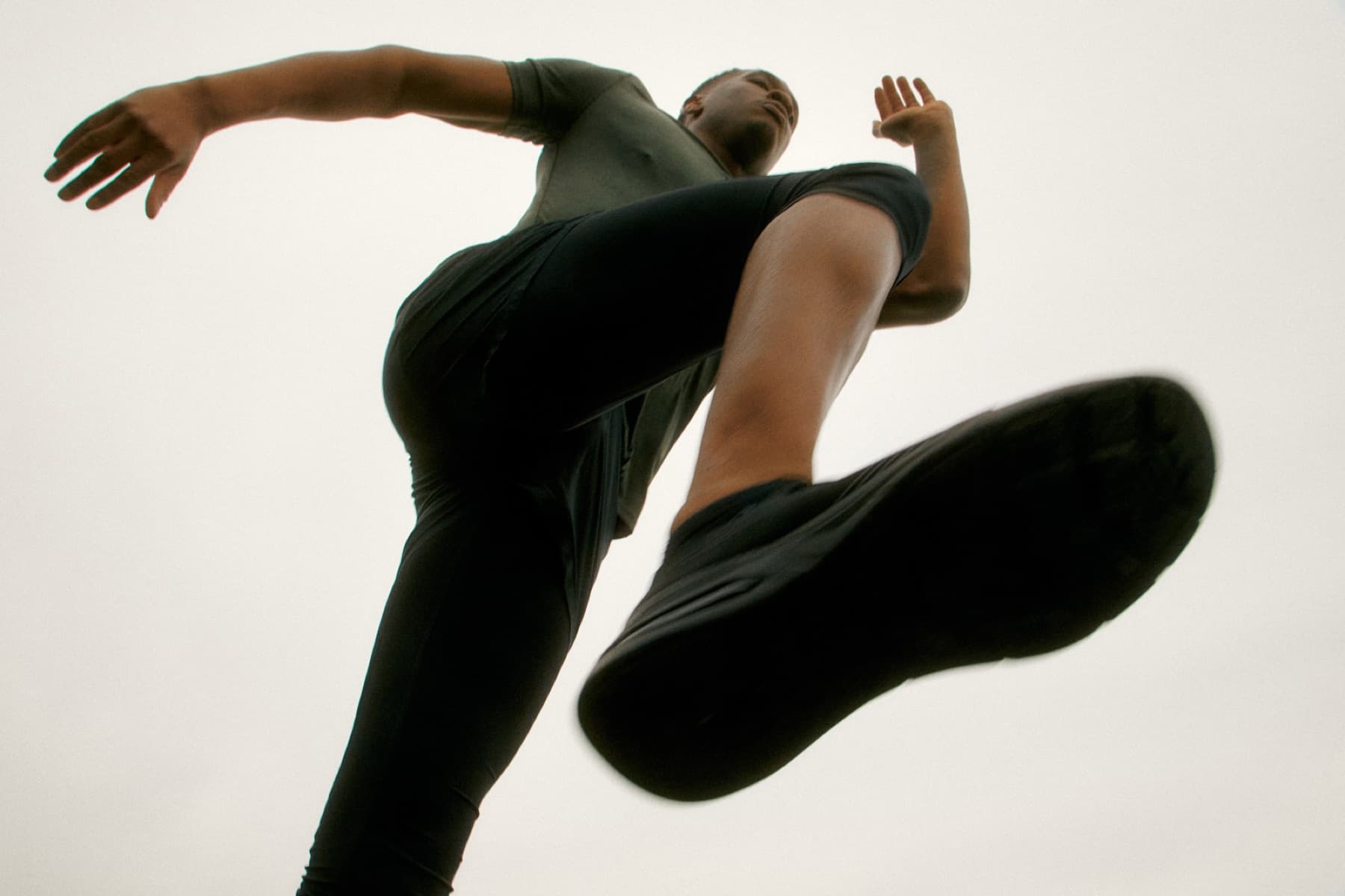 Athlete jumping above the camera during an outdoor warm-up